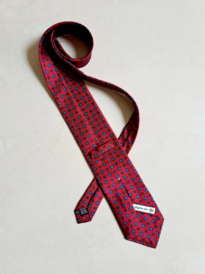 CRAVATTA MOTIVO FIORELLINO ROMBO ROSSO BLU